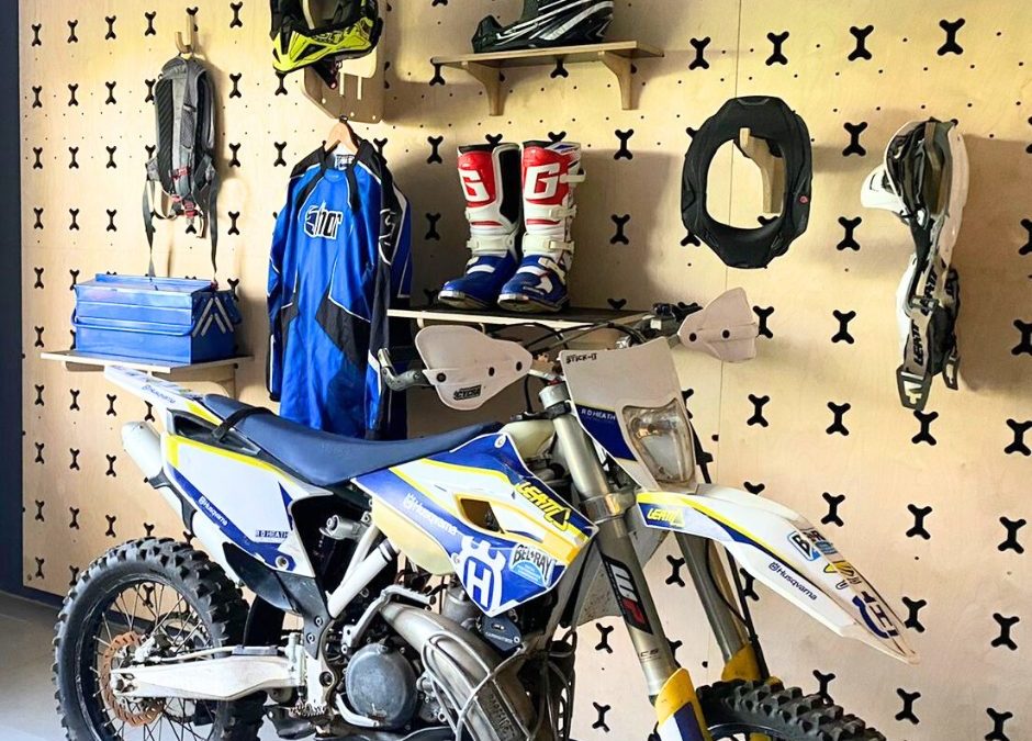 Garage Storage Shelving And Hooks With Off Road Biking Equipment Mounted